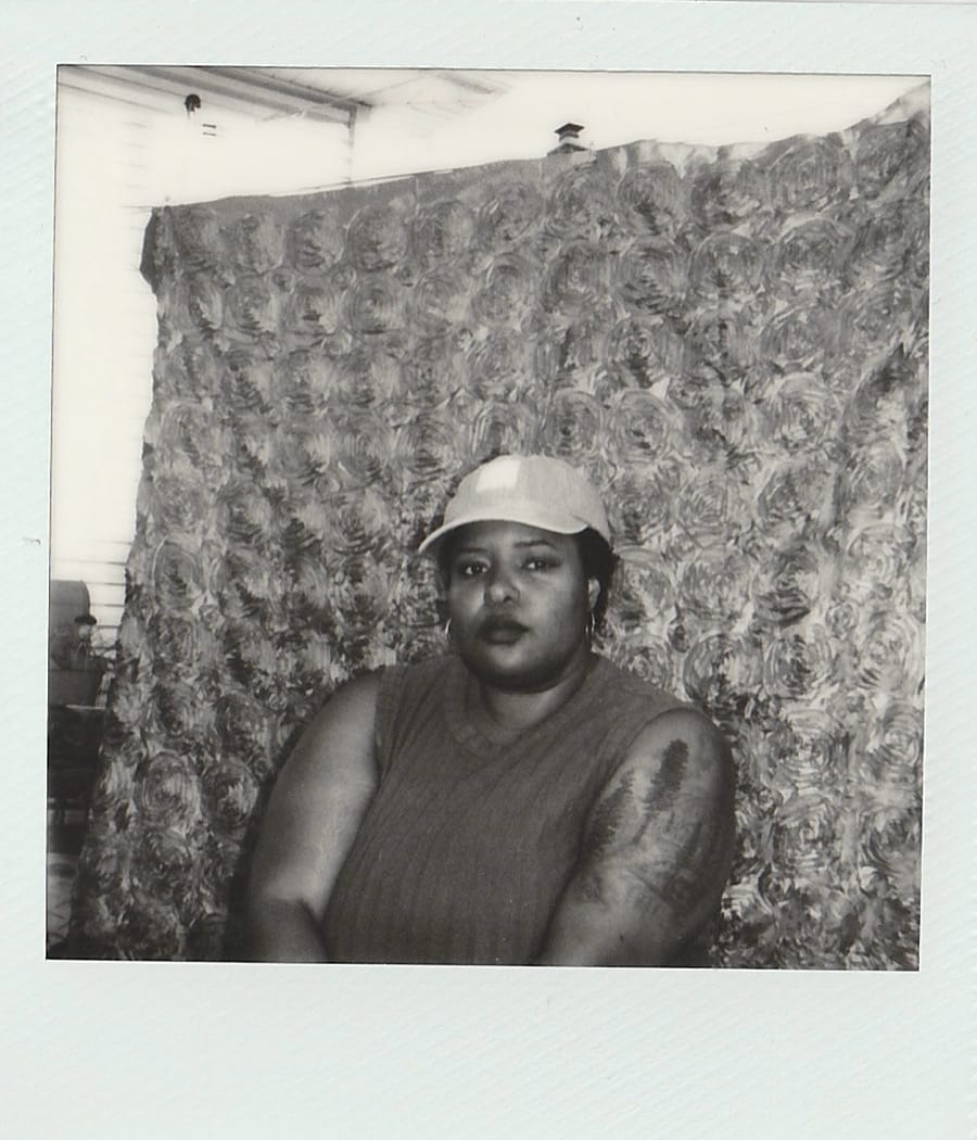 Black & white self-portrait of Keisa taken on Polaroid film